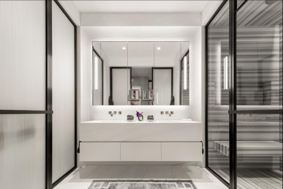 A white bathroom with glass doors