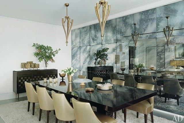 A dining room with black and gold furniture and fixtures